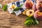 A group a ripe peaches on wooden table