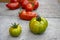 Group of ripened tomatoes in two boxes, red and green fruits after harvest, ready to eat, pepper and green zebra tomatoes