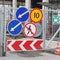 Group of road traffic signs on the metal gate of the construction site