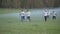 A group of rock musicians having fun running with the tools in a smoke-filled field. Funny shot.