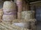 Group of round hay bales straw bales in a barn