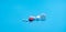 Group of round and oval white tablets pills, red sugar-coated tablets pills on blue background. Pharmacy shop and pharmacy