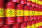 Group of rows of red stacked oil drums in storage warehouse