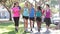 Group Of Runners Jogging Down Urban Street