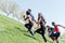 Group of runners running up a hill.