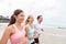 Group running on beach jogging