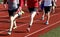 Group running on a track in spikes