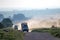 Group of safari vehicles charging to a potential kill while on safari in Kenya