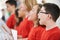 Group Of School Children Singing In Choir Together