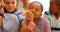 Group of school children studying anatomy in classroom with teacher at desk 4k