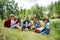 Group of school children with teacher on field trip in nature, learning science.