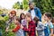 Group of school children with teacher on field trip in nature, learning science.