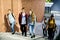 Group of school friends walking down staircase