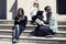 Group of school girls sitting on steps in campus