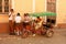 Group of school kids and pedal taxi