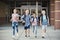 Group of school kids running as they leave elementary school at the end of day