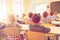 Group of school kids and teacher in classroom