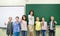 Group of school kids and teacher showing thumbs up