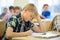 Group of school kids writing test in classroom