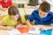 Group of school kids writing test in classroom