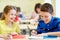 Group of school kids writing test in classroom