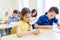 Group of school kids writing test in classroom