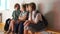 Group of schoolchildren with backpack sitting on wooden bench at school corridor. Back to school. Teenagers greet and