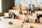 group of schoolchildren with notebooks studying on wooden tribune