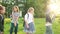 A group of schoolmates classmates having fun in the park. The boy does an acrobatic trick, a blurred video