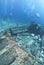 Group of scuba divers exploring a shipwreck.