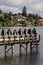 Group of scuba divers on wooden jetty