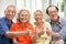 Group Of Senior Chinese Friends Relaxing At Home