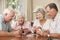 Group Of Senior Couples Enjoying Game Of Cards At Home