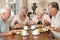 Group Of Senior Couples Enjoying Meal Together