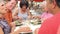 Group Of Senior Friends Enjoying Meal In Outdoor Restaurant