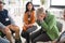 Group of senior people sitting in circle during therapy session, consoling depressed woman.