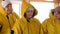 Group senior woman in yellow waterproof jacket on passengers ship board. Mature women in protective jacket while rescue