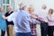 Group Of Seniors Enjoying Dancing Club Together