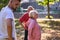 A group of seniors follows a trainer, engaging in outdoor exercises in the park, as they collectively strive to maintain