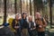 Group of seniors hikers outdoors in forest in nature, looking at camera.