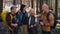 Group of seniors hikers outdoors in forest in nature, looking at camera.