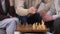 Group of seniors playing chess at nursing home, enjoying leisure time together