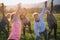 Group of seniors with sport instructor doing exercise outdoors in nature at sunset, active lifestyle.