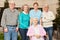 Group of seniors together with caregiver