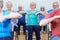 Group Of Seniors Using Resistance Bands In Fitness Class