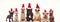 Group of seven adorable dogs wearing santa claus hats standing together