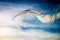 Group of seven small planes moving through blue sky and leaving the coloured smoked mark behind them. Airshow of small aircrafts