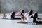 Group of several european women doing yoga posture anantasana.