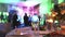 Group of silhouetted people dancing in a dark banquet hall for a wedding reception.The Wedding Banquet, people dance -