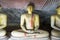 Group of sitting Buddha statues in cave buddhist temple